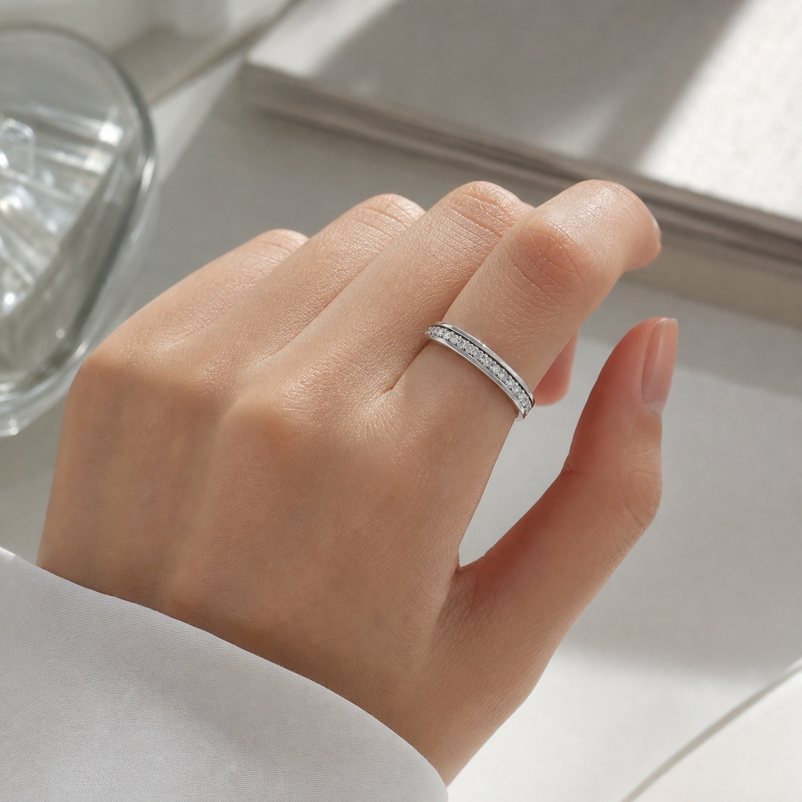 Silver moissanite spinner ring worn on hand