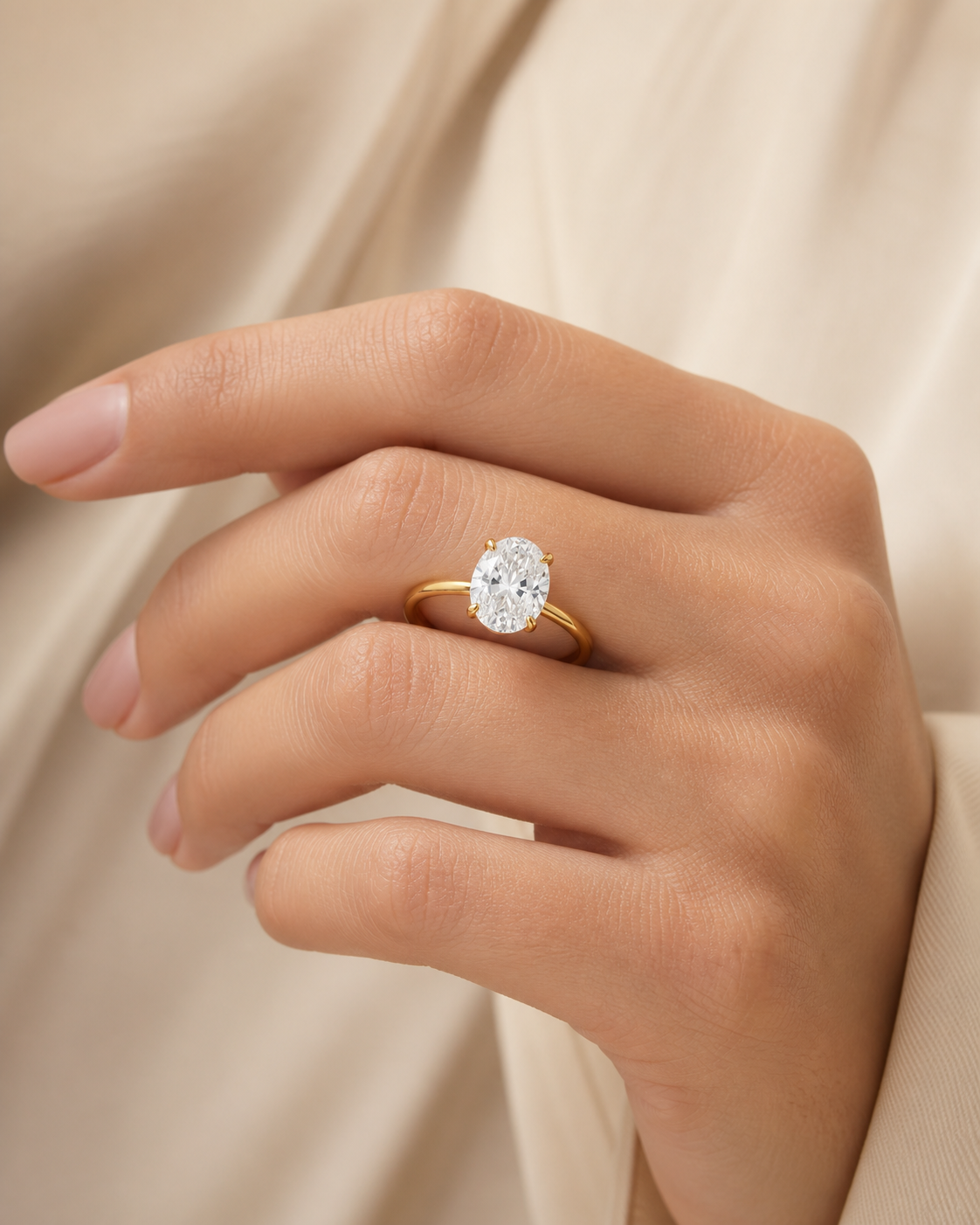 Vowmira oval solitaire ring, worn on hand